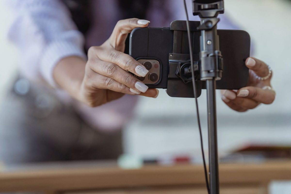 Smartphone being mounted on a tripod to film an audition video at home